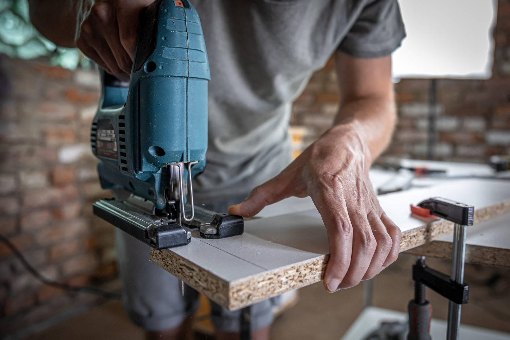 Skilled hands at work with a circular saw, symbolizing our diverse services. From building, construction, and repairs, to transformative remodeling—we're your ultimate home improvement partner at Lonestar Precision Builders.